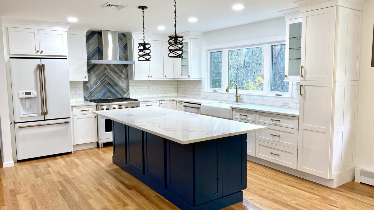 Island in Custom Blue Color, New Window facing Yard with Sink Under, GE Cafe Appliances Matte White Finish, Oak Flooring in Berkeley Heights, Union County NJ