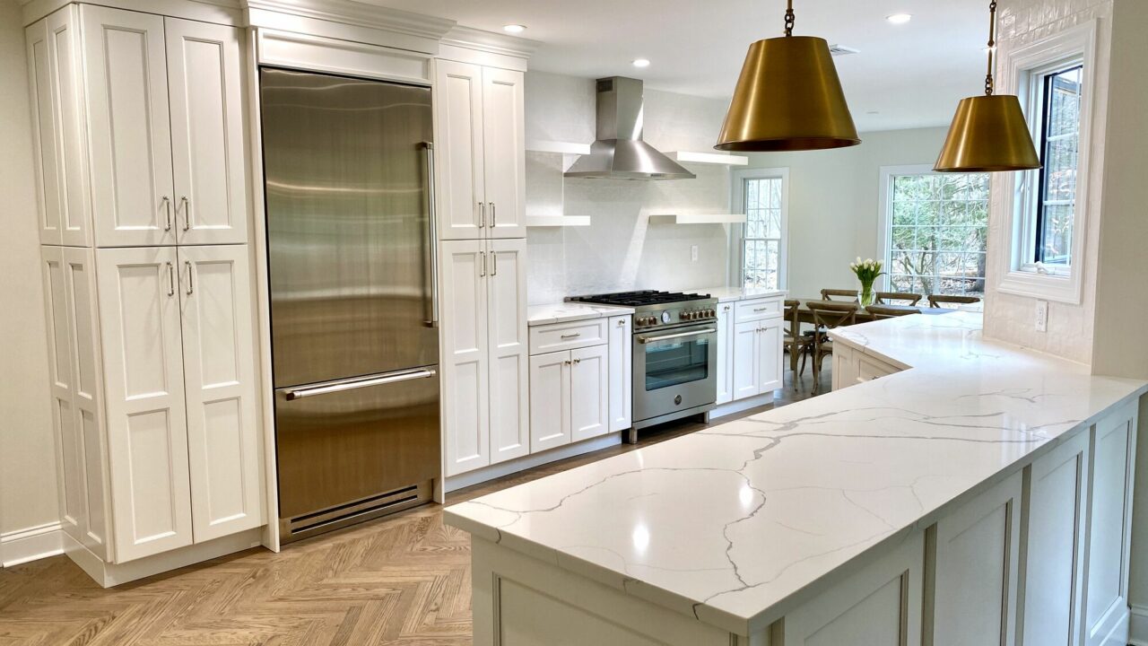 Open Concept Modern Kitchen with White Shaker Cabinetry, Open Shelving, Herringbone Oak Flooring, Calacatta Quartz Counters, Kohler Fixtures, Andersen Windows in Ramsey, Bergen County NJ