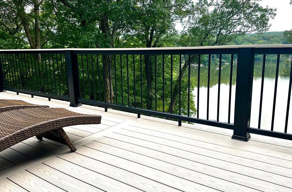 Image of a 2-story deck in Bloomingdale, Passaic County, NJ, featuring Timbertech PVC Decking, Composite Rail with Drink Top, and Round Metal Balusters.