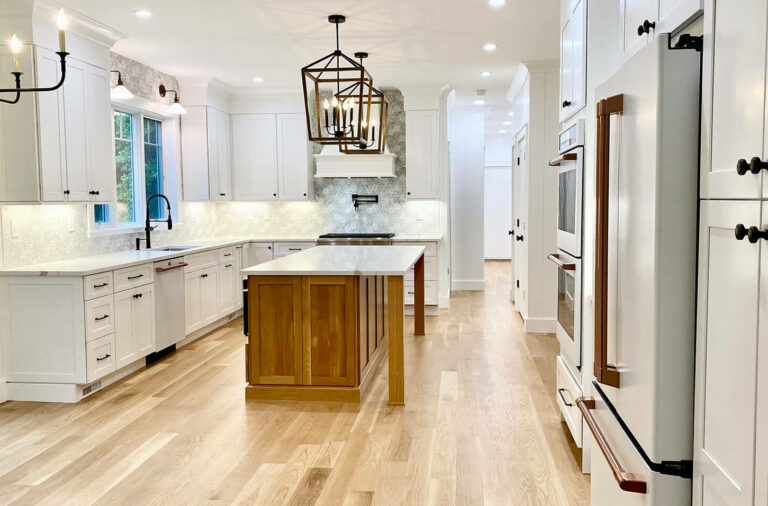 Kitchen Remodeling with Brighton White Oak Island, White Oak Flooring, MDF Paneling, Marble Backsplash, Kohler Plumbing Fixtures, GE Cafe Matte White Appliances