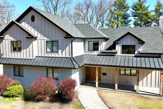 front-view-of-white-brick-and-siding-with-black-a-line-roof-and-stone-path-walkway