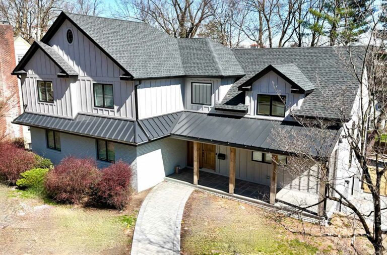 front-view-of-house-with-a-line-roof-and-white-brick-and-siding-and-black-roof