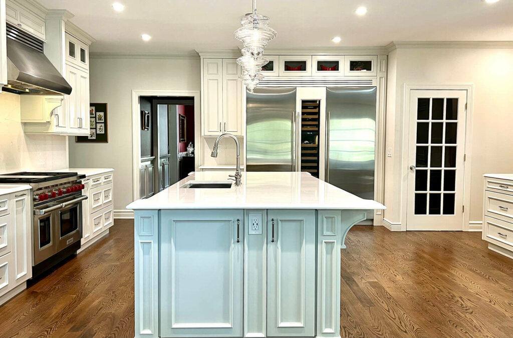 Custom kitchen with white island and stainless steel appliances