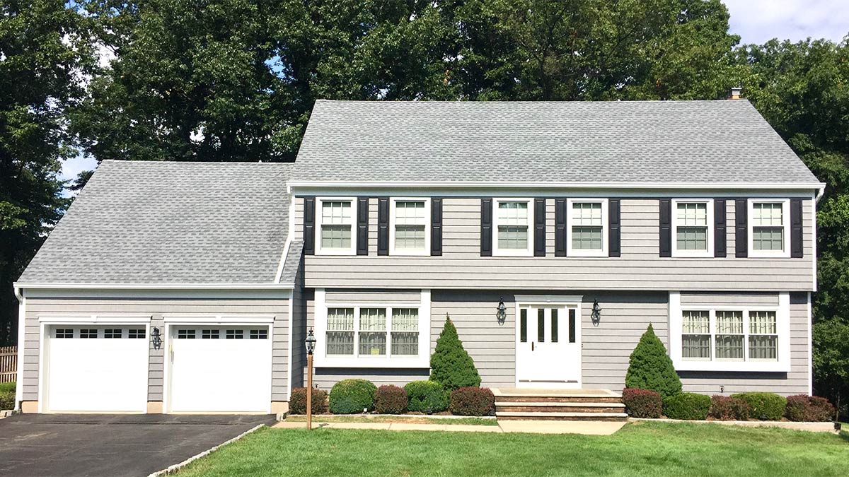 A Cedar Knolls, NJ home with a new roof installation viewed from the front.