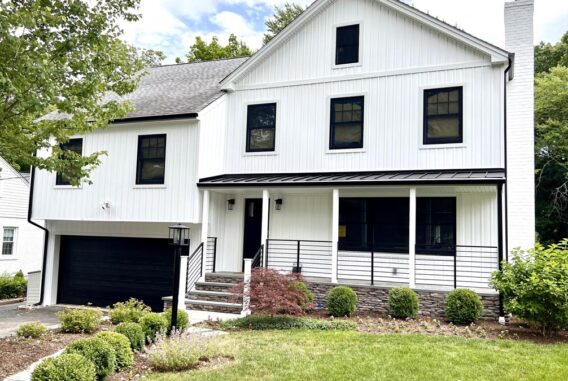 white-siding-house-with-railing-next-to-grass