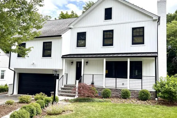 white-siding-house-with-railing-next-to-grass