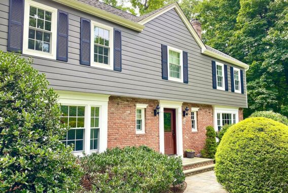 blue-and-brick-house-with-shrubs-and-front-door