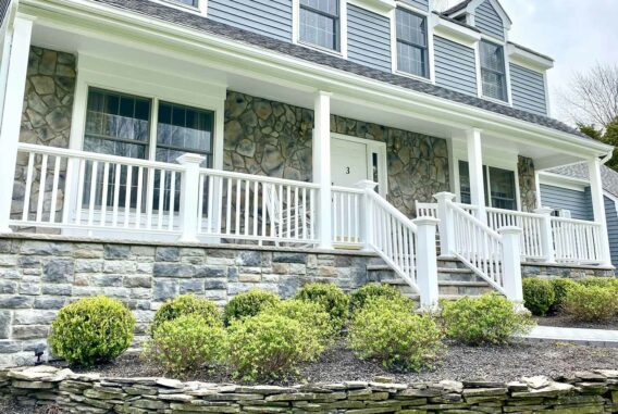 blue-house-with-white-porch-and-stone-steps