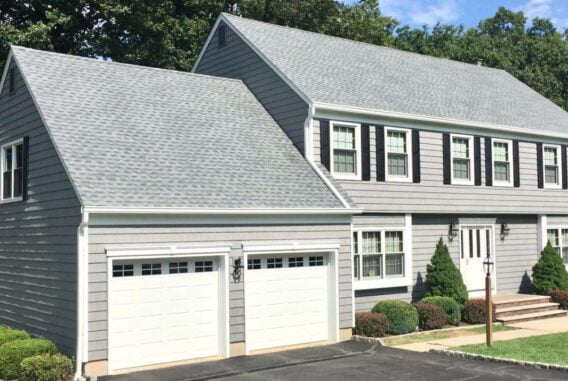 grey-colonial-home-near-green-lawn